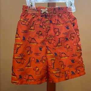 Orange and blue dinosaur toddler swim trunks
